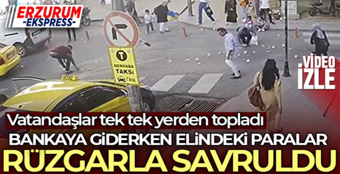 Bankaya giderken elindeki paralar rüzgarla savruldu: Vatandaşlar tek tek yerden topladı